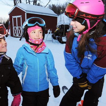 Woman student working with young skiers