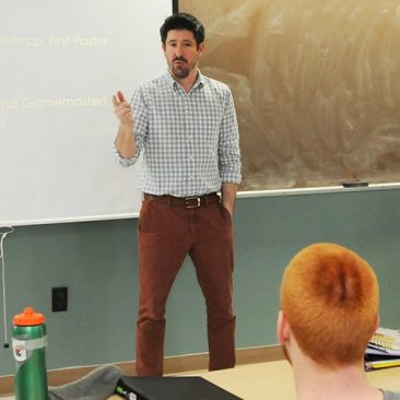 Male professor teaching a classroom of students
