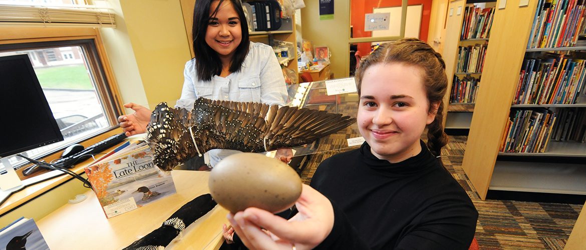 Two female students working on a project about birds