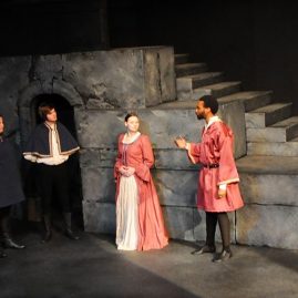 Four students acting on stage during theatre rehearsal