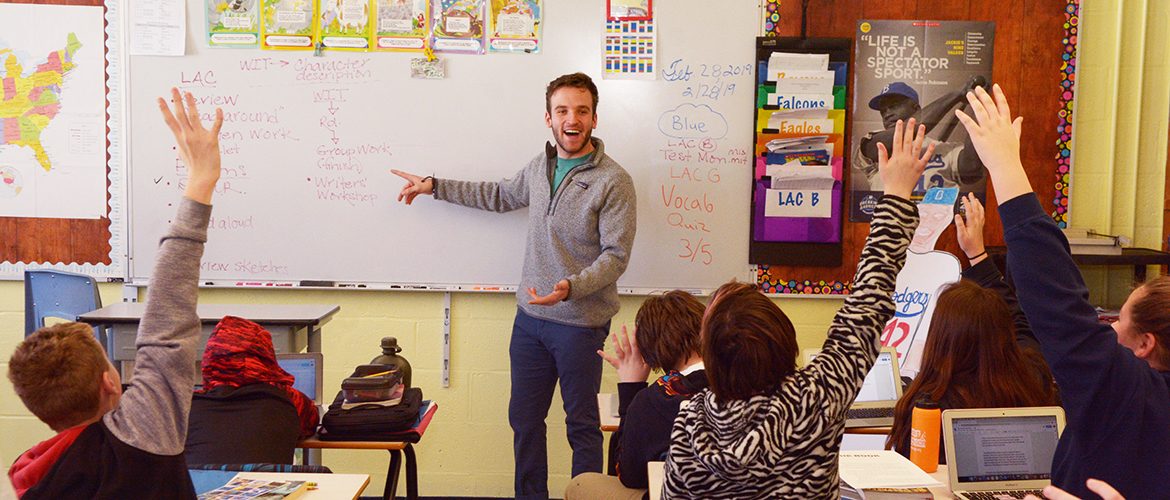 Student-teacher in a classroom with school children