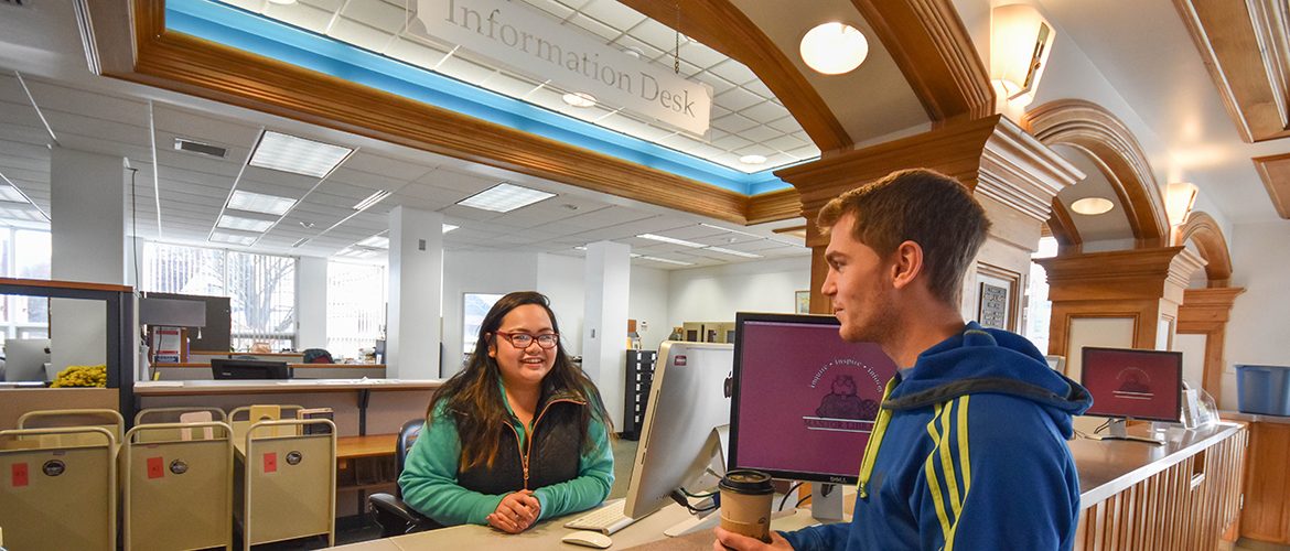 Student worker at Mantor Library assisting a student