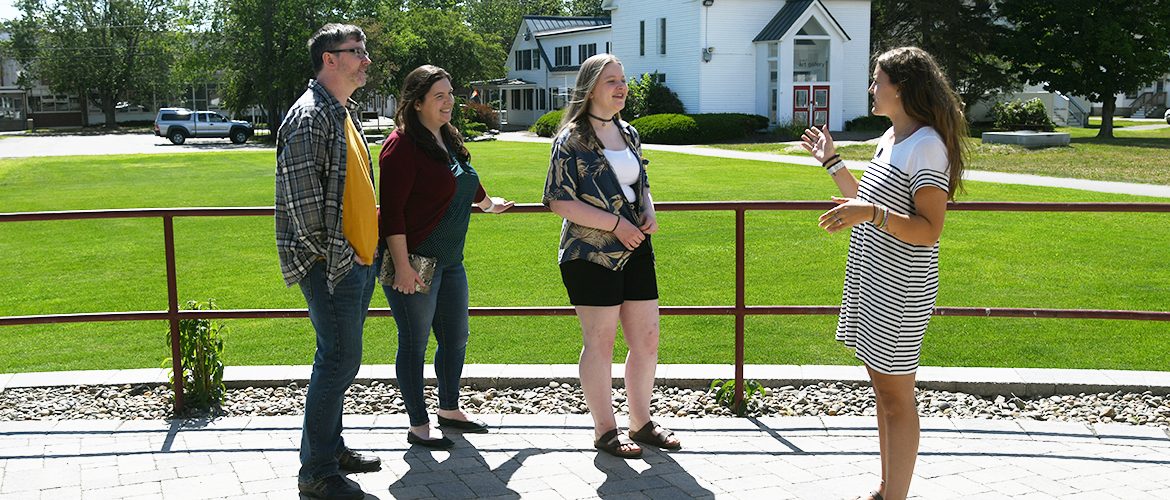 Family and student tour guide on a campus tour