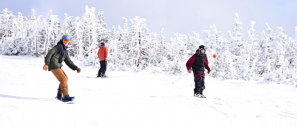 Students snowboarding and skiing at Sugarloaf ski resort