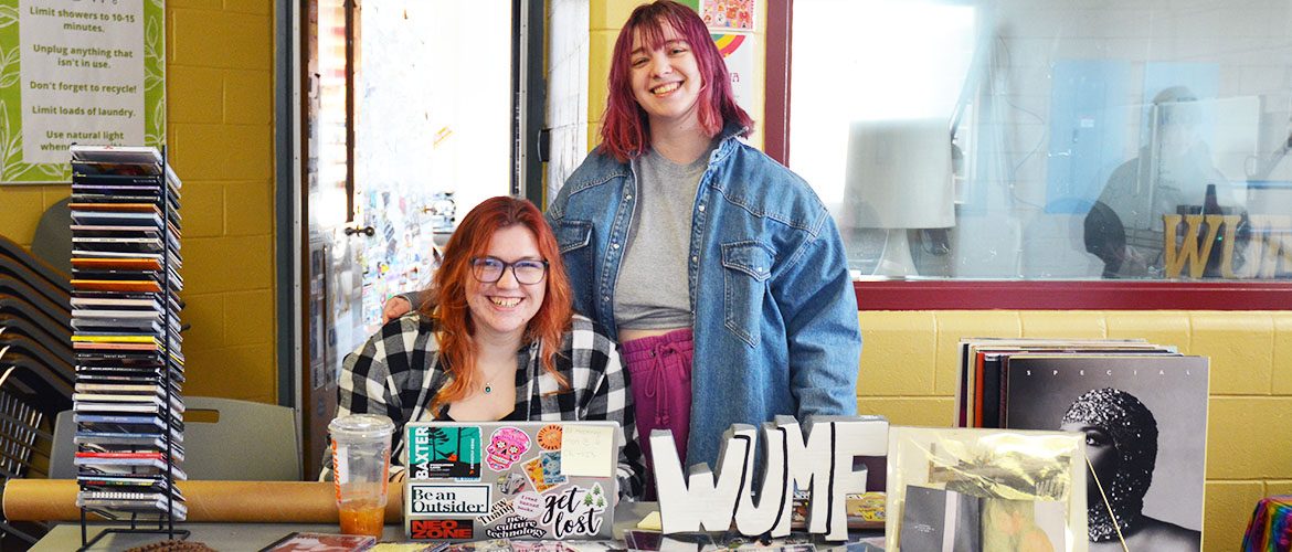 Students with WUMF student radio station outside the on-air studio