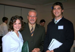 Image of two students and a faculty member at an event