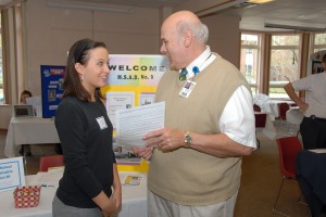 Image of a school superintendent and student talking at a job fair