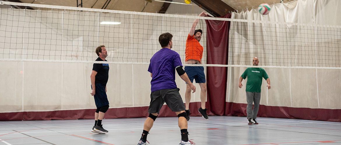 Adults playing volleyball