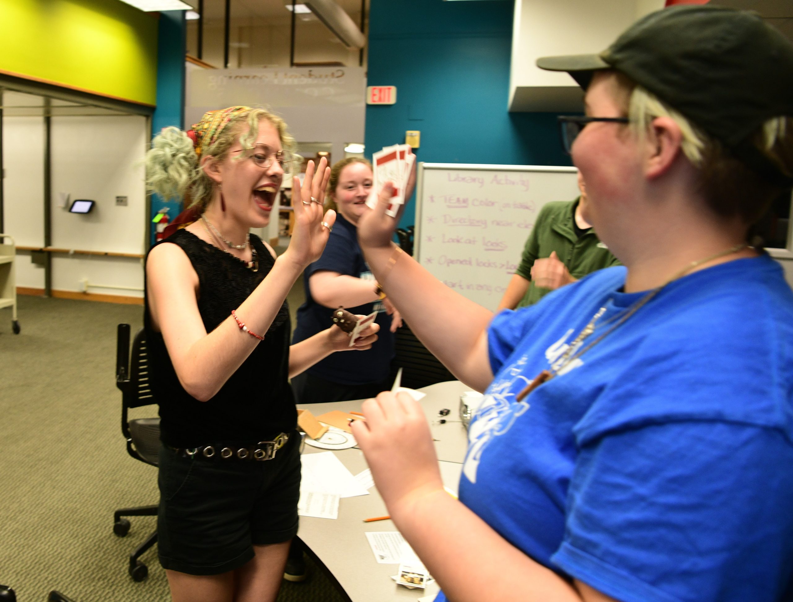 Students sharing a high-five in the student learning commons
