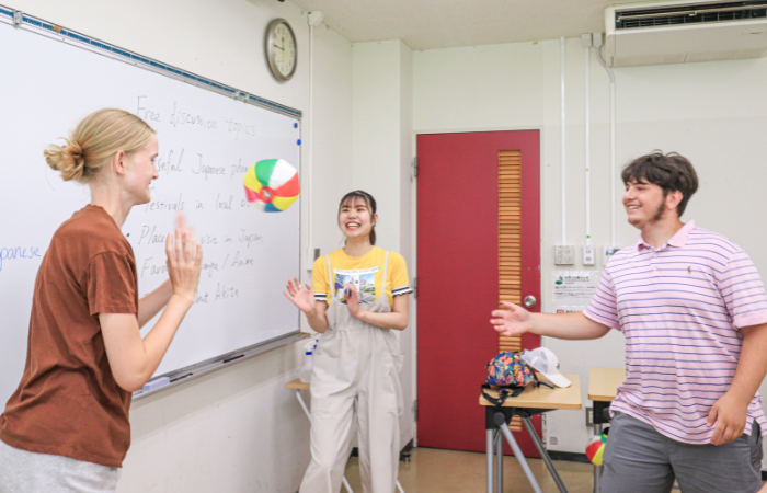 Students playing with a beach ball in classroom