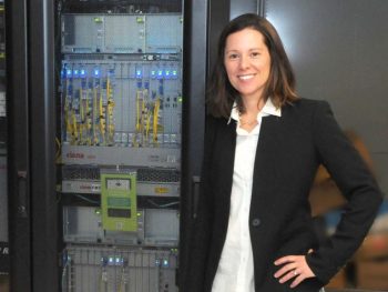 Meredith Swallow standing near a server on the UMF campus