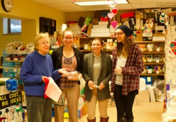 Mary Ryan (left) helps a group of UMF students find materials for a project. (from left to right: Mary Ryan, Mattie Lajoie, Nicole Pilote and Olivia White)