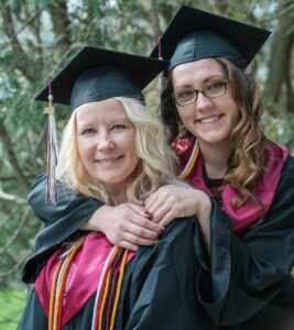 Aimee DeGroat, left, gets a hug from her sister Sara Turner prior to Saturday's graduation at University of Maine Farmington. Courtesy of Sun Journal, photo by Russ Dillingham.