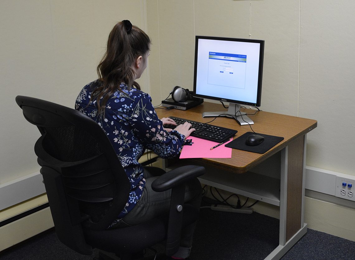 Student at one of twelve supervised testing stations at UMF Testing Services facility.