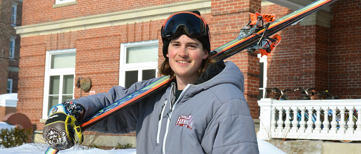 student holding skis