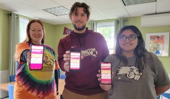 Students holding up their phones with new UMF Smart app
