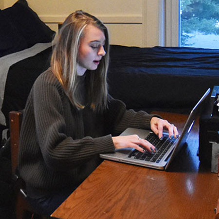 Student taking an online course on a laptop